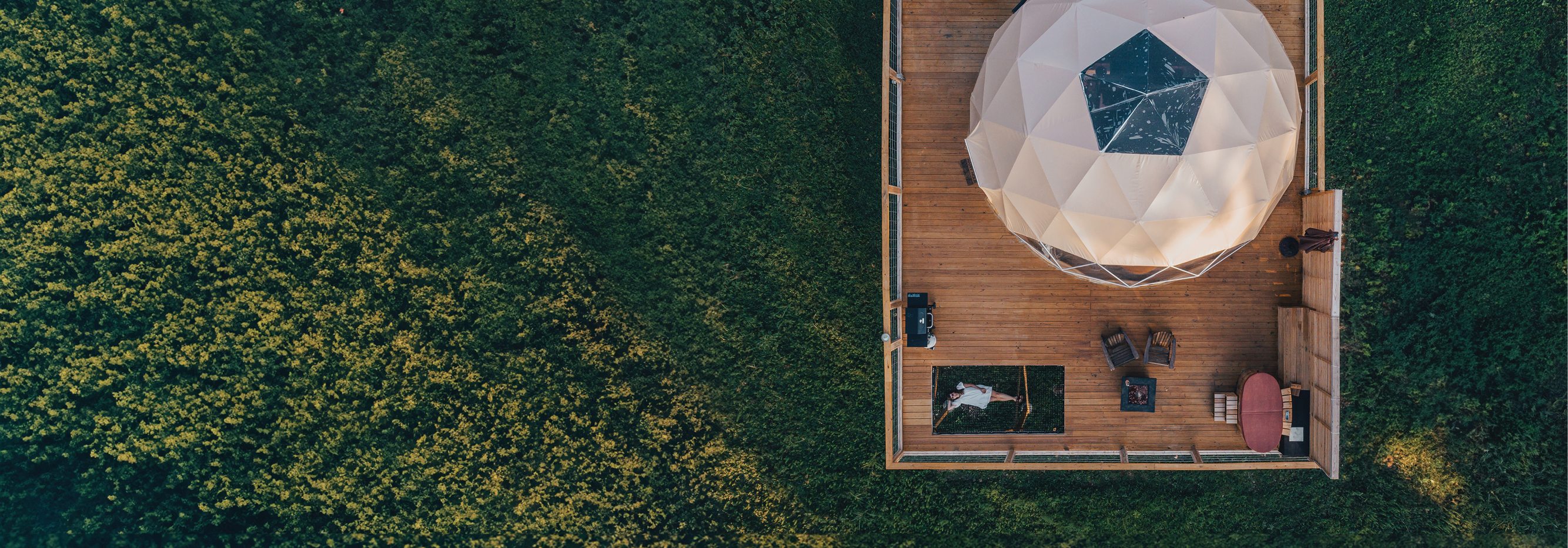 Aerial photo of a yurt in a field.