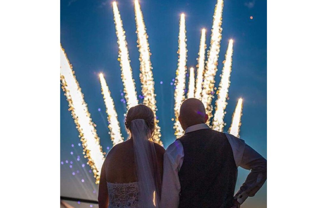 Bride and groom enjoying fireworks.