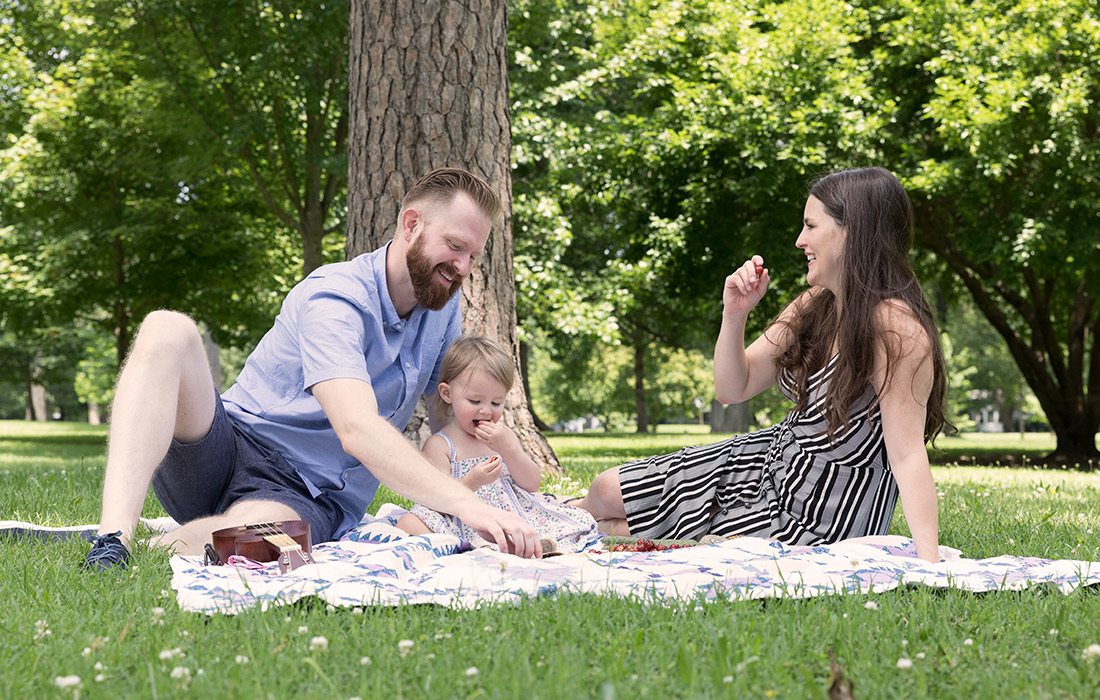 Family of three on a picnic in Phelps Grove Park in Springfield MO