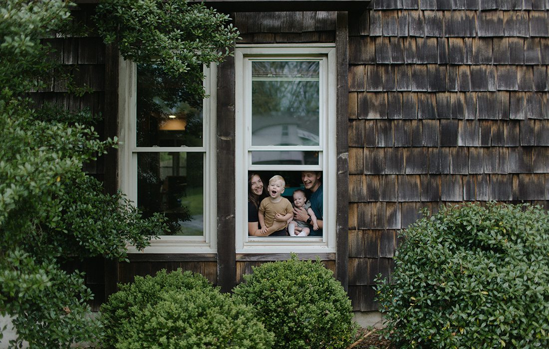 Olivia Jahnke and her family through a window at home