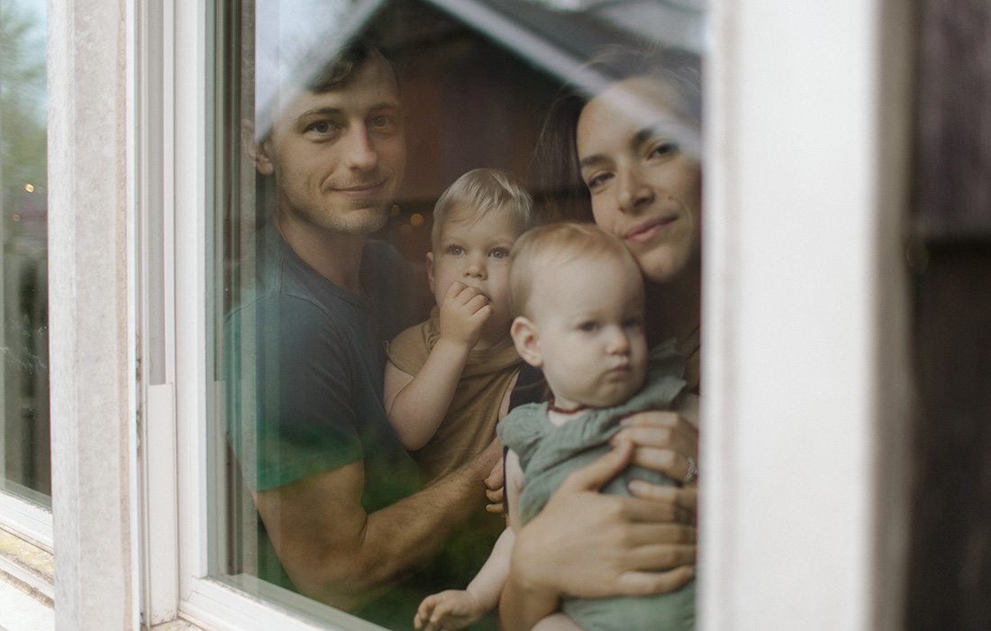 Olivia Jahnke and her family through a window at home