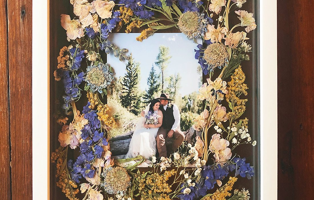 Pressed wedding bouquet in a wooden photo frame