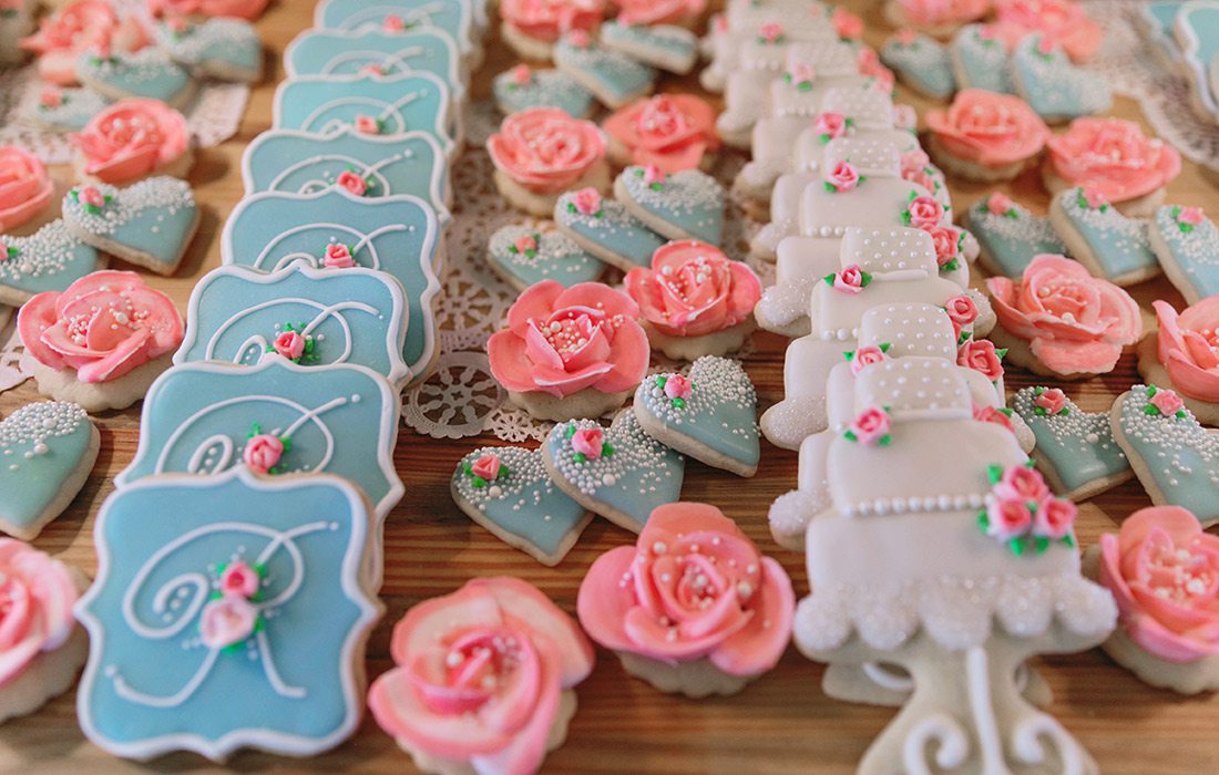 Different colored sugar cookies arranged in rows.