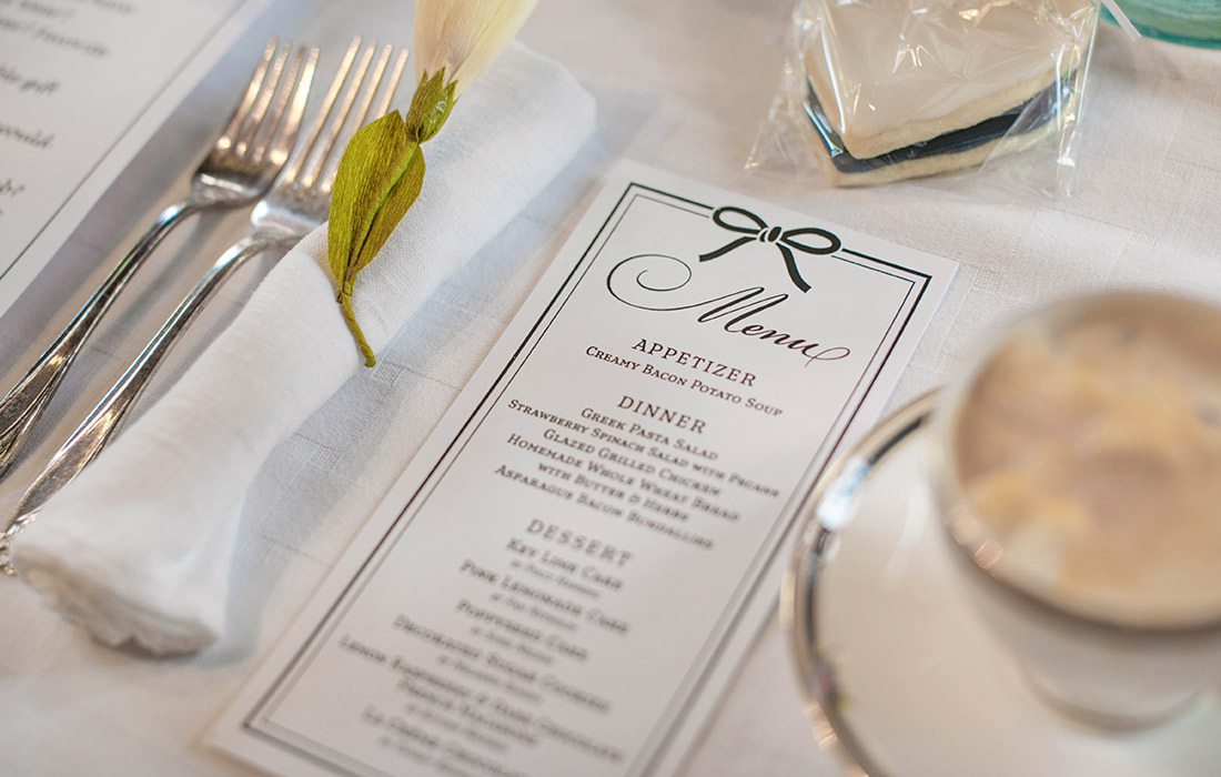 Menu set on table with silverware.