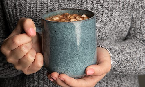 Woman holding a mug of hot cocoa