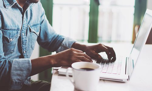 man working remotely on a laptop