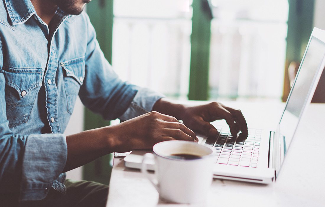 man working remotely on a laptop