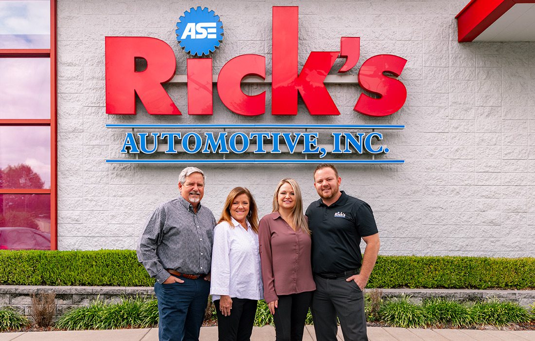 Rick Hughlett poses in front of Rick’s Automotive with his wife, Karen Hughlett, his daughter, Kala Comfort and his son-in-law, Travis Comfort.