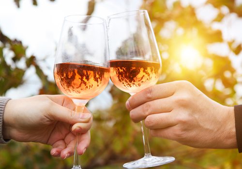 Clinking glasses of rose wine