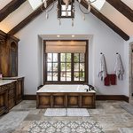 Slider Thumbnail: Tudor style master bath with skylights and wooden fixtures.