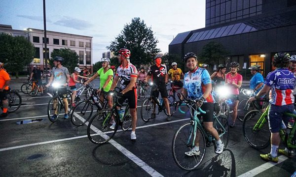 SBC Moonlight Bike riders in parking lot.