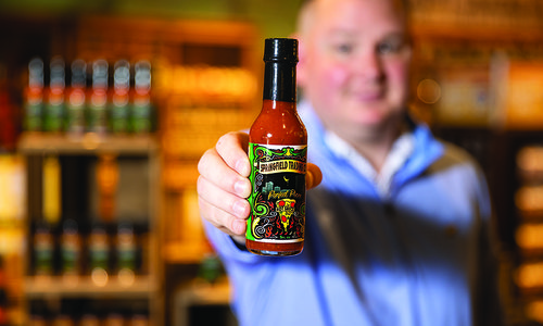 Anthony Brent with locally made Springfield Trading Company hot sauce.