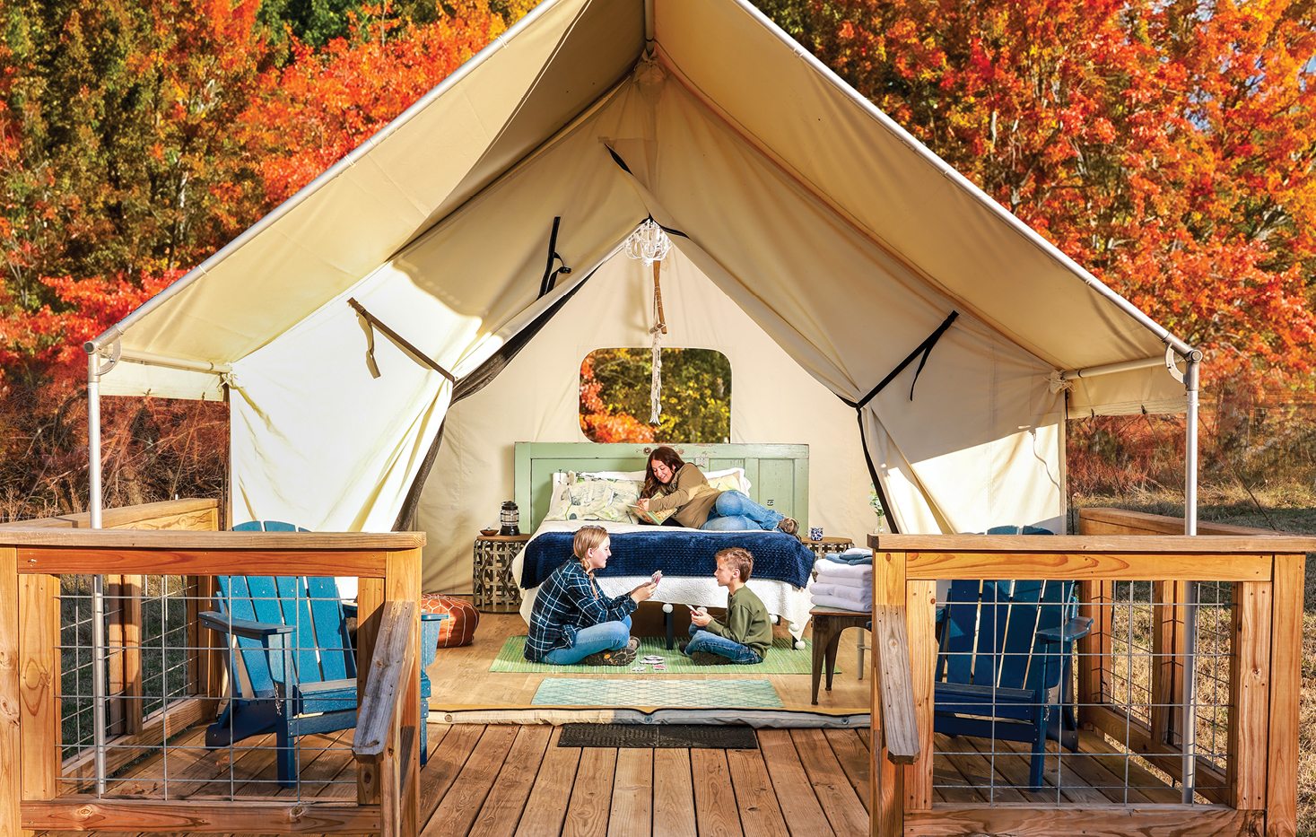 A yurt against a bright, fall-colored background with brown and orange leaves