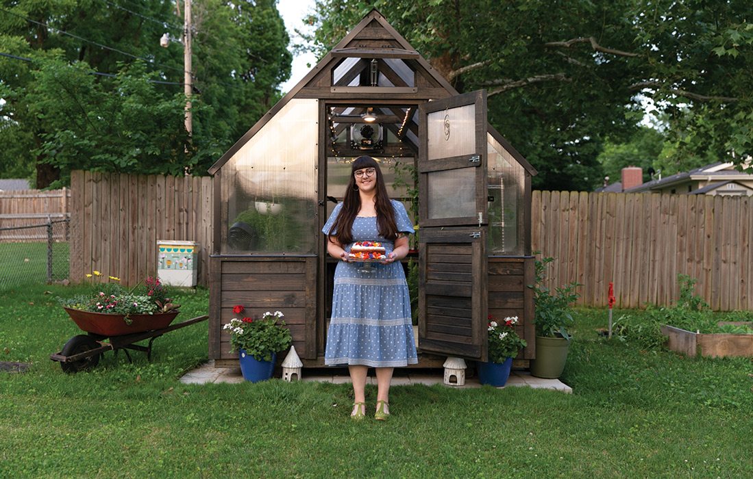 Woman standing holding cake