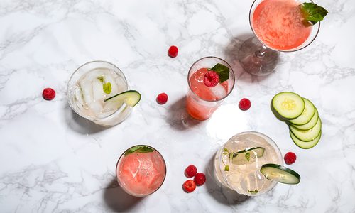 Summer cocktails with ingredients on marble counter