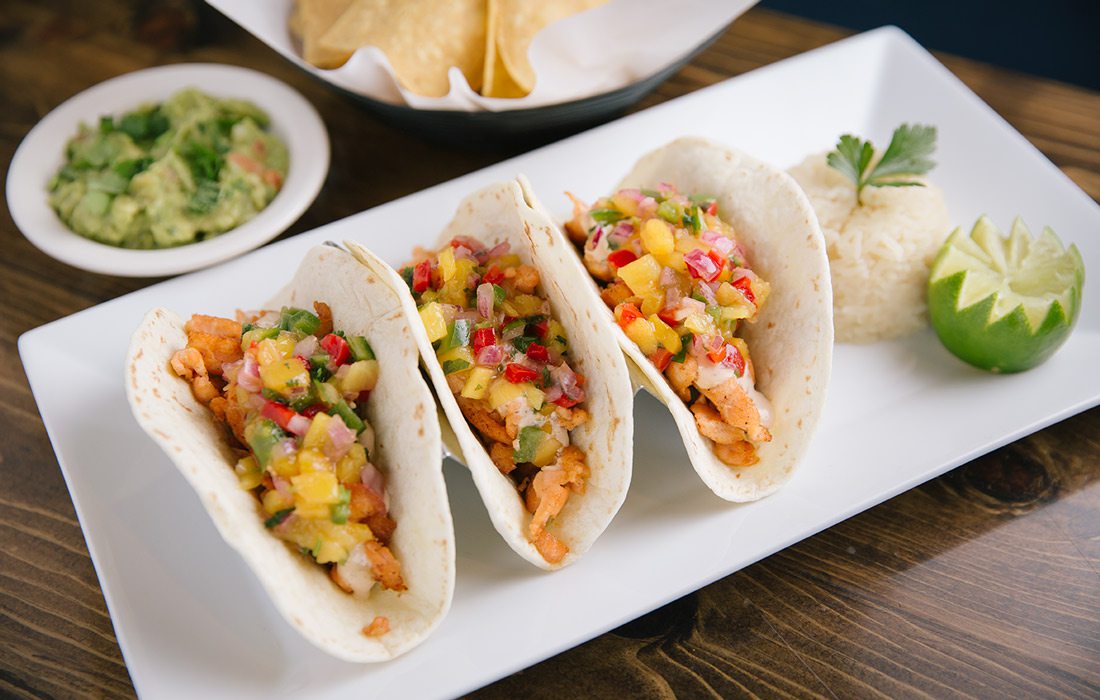 Tacos de Salmon on a white plate.