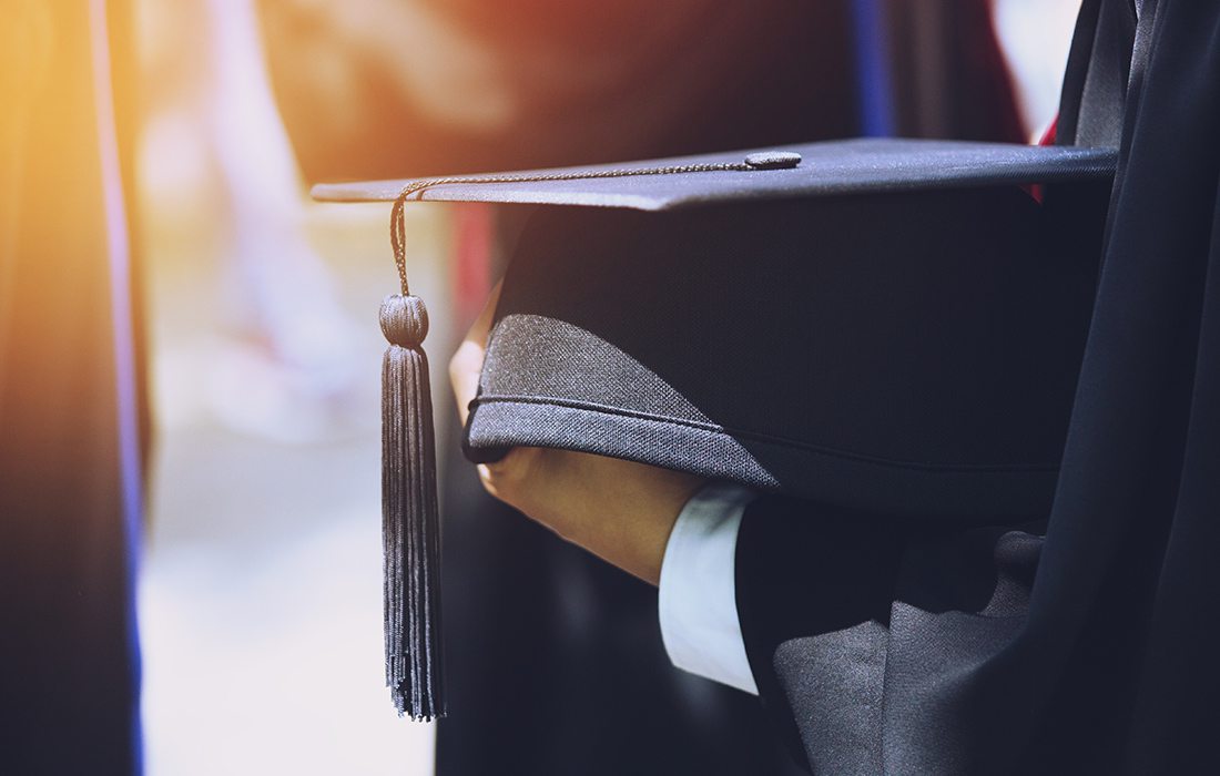 person holding a graduation cap