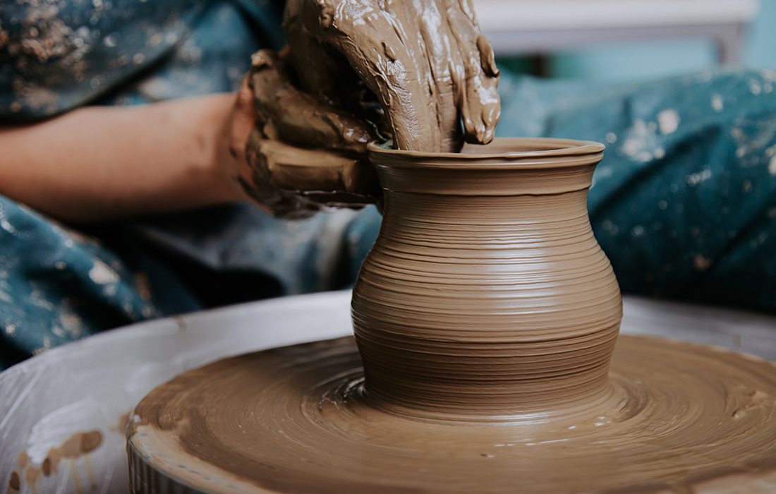 Throwing clay on a potter's wheel