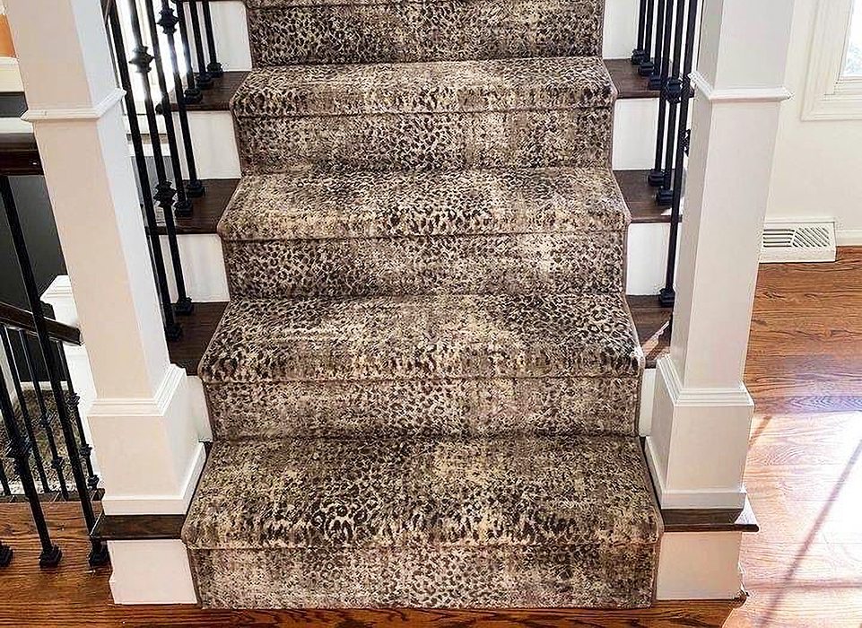 Cheetah Print rug on wooden staircase with black iron railing