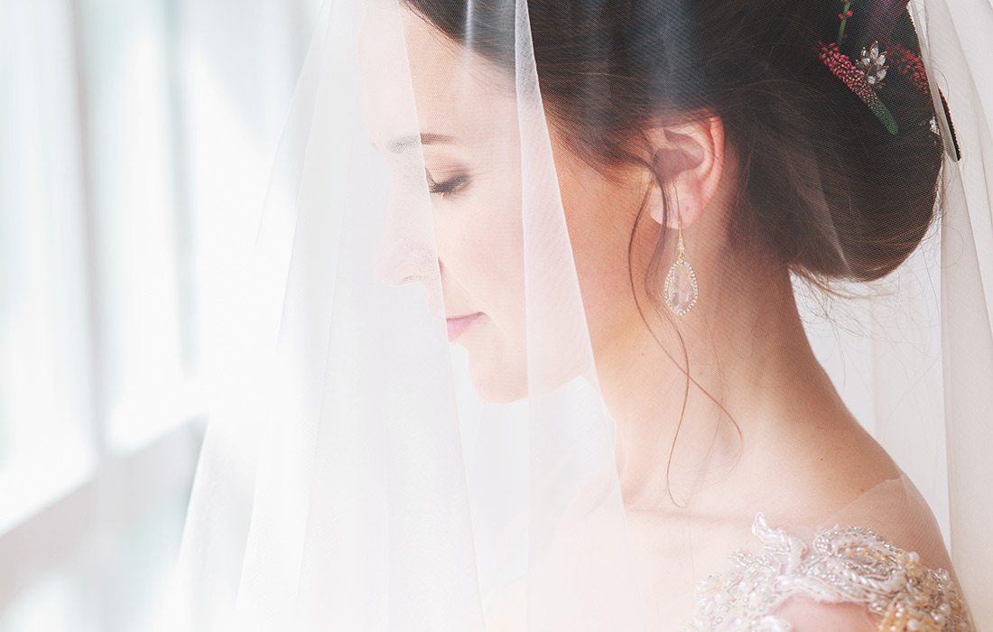 Closeup of a young bride with a veil