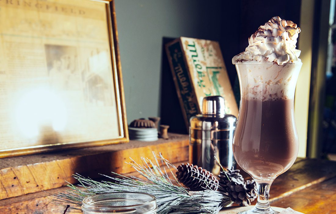 winter spice cocktail with whipped cream on top