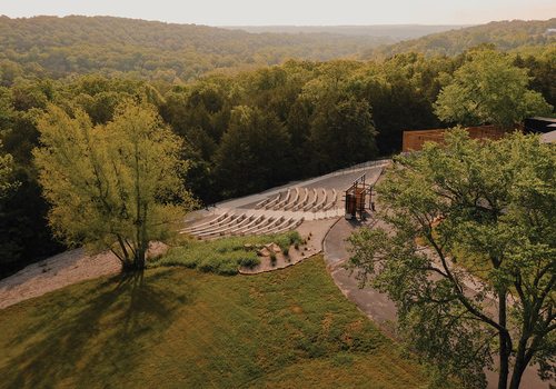 An outdoor wedding chapel overlooks the Finley River, the Riverside Bridge and rushing waterfalls.