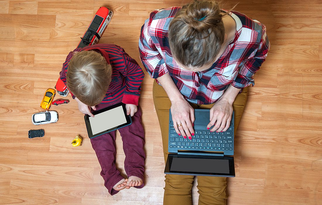 Mother working from home with her son