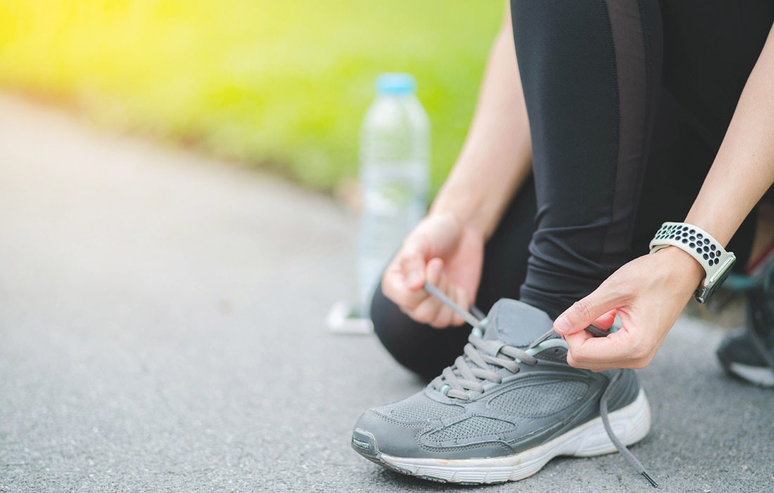 Lacing up walking shoes stock image