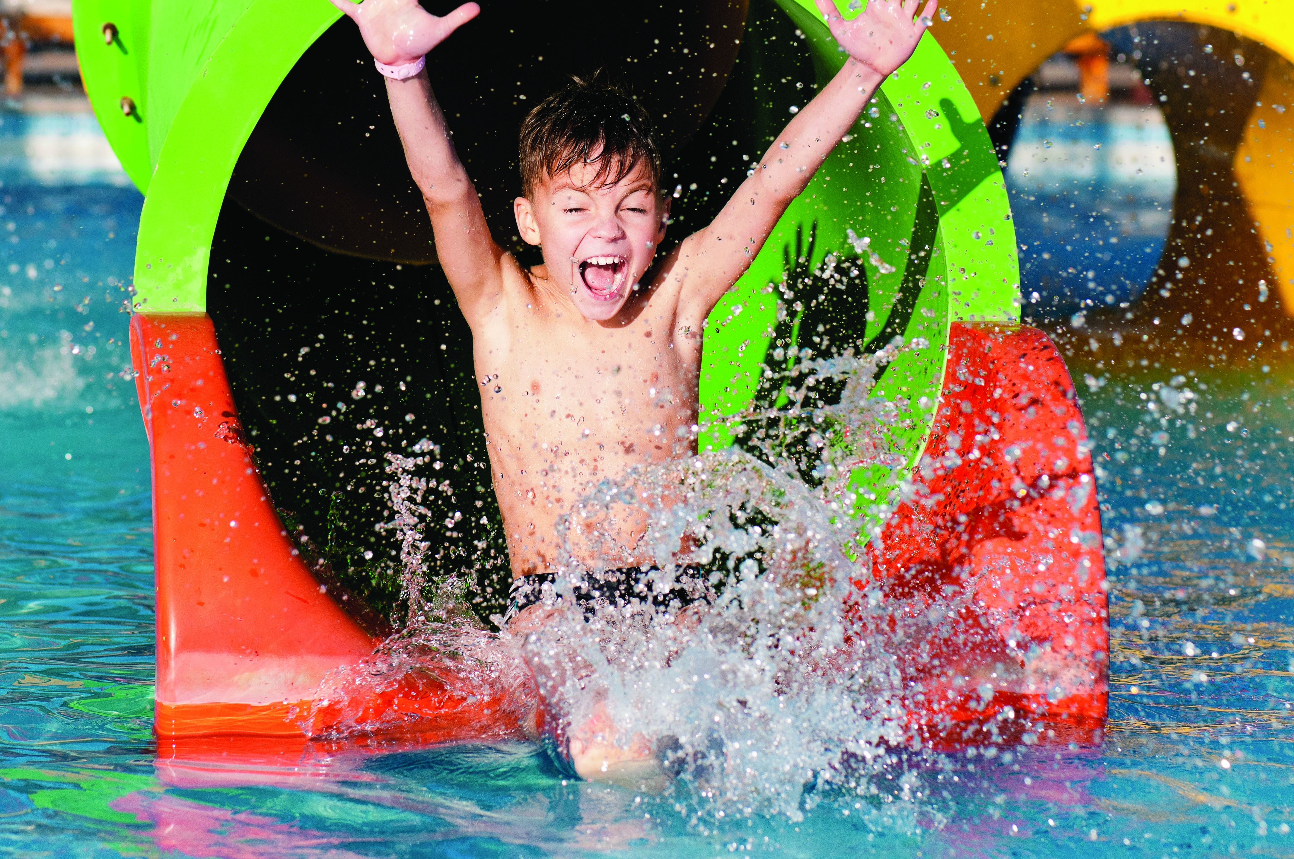 A boy goes down a waterslide.