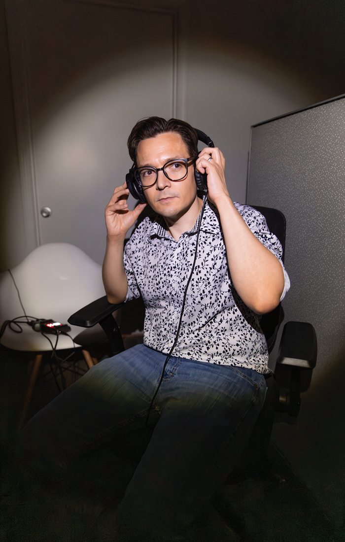 Digital Editor Jamie Thomas listening on headphones.