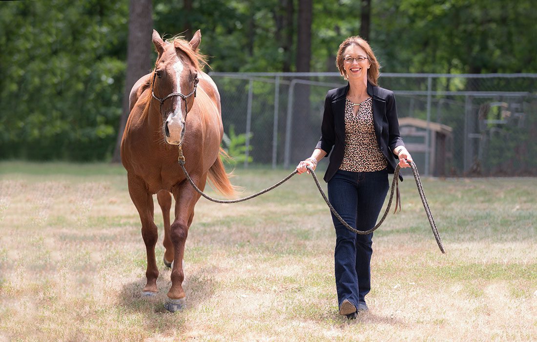 Lora Newman walking her horse, Chief