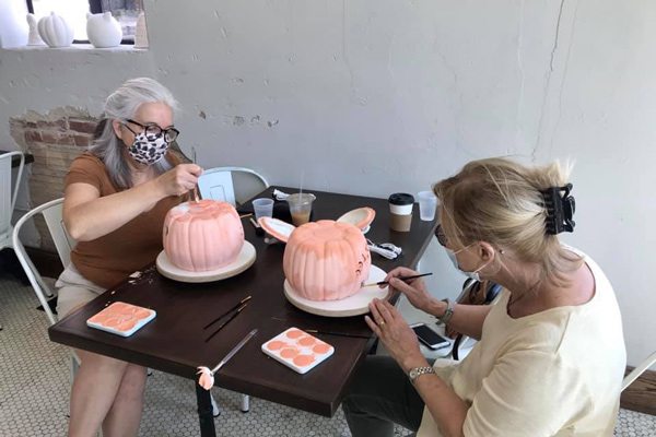 Women paint pottery at Artistree Pottery in Rountree Springfield MO