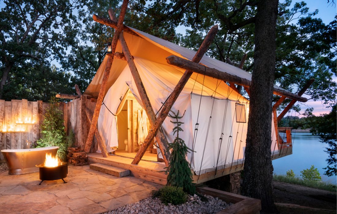 At night, the glamping tents glow in the moonlight.