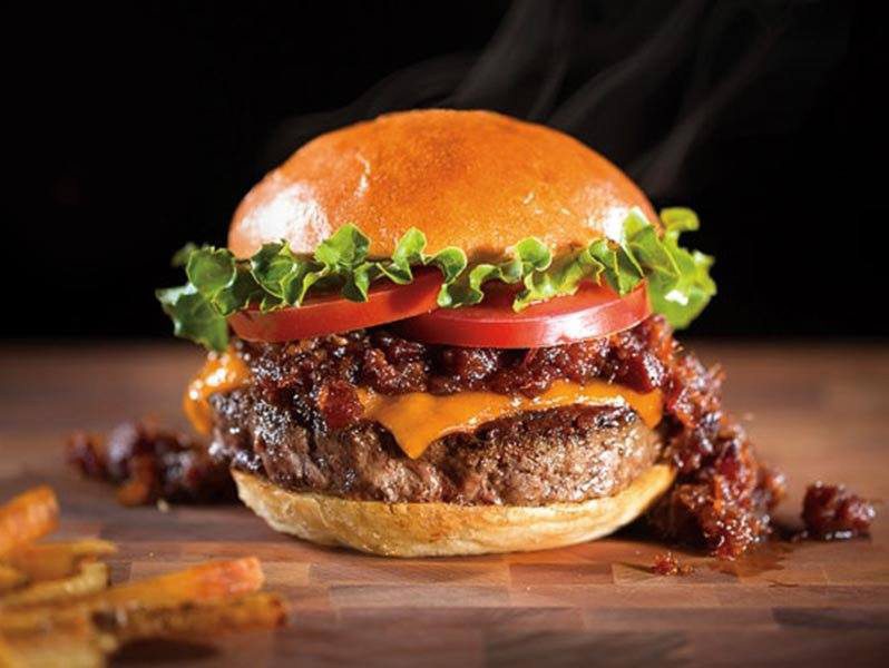 Big burger with cheese, bacon, lettuce and tomato.