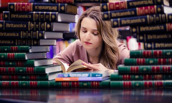 College Student Surrounded by Books