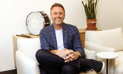 Positronic general manager Jay Sandidge seated beside a snare drum.