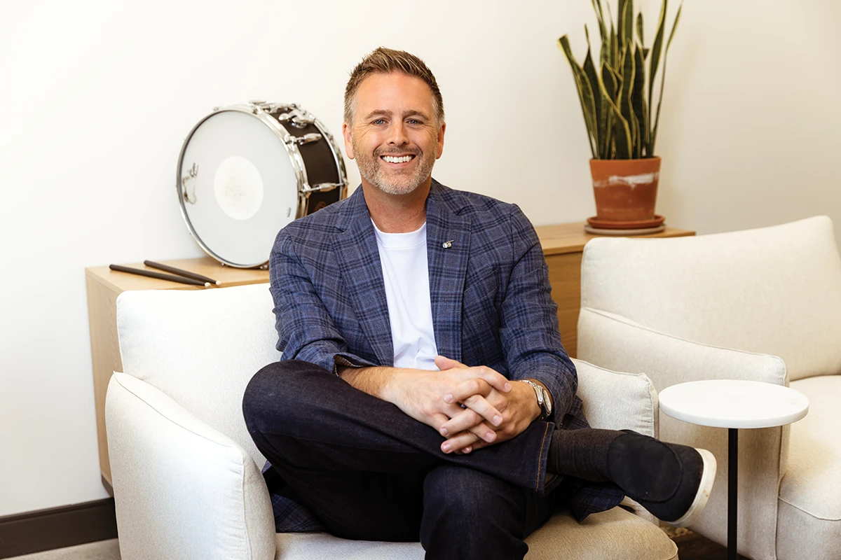 Positronic general manager Jay Sandidge seated beside a snare drum.