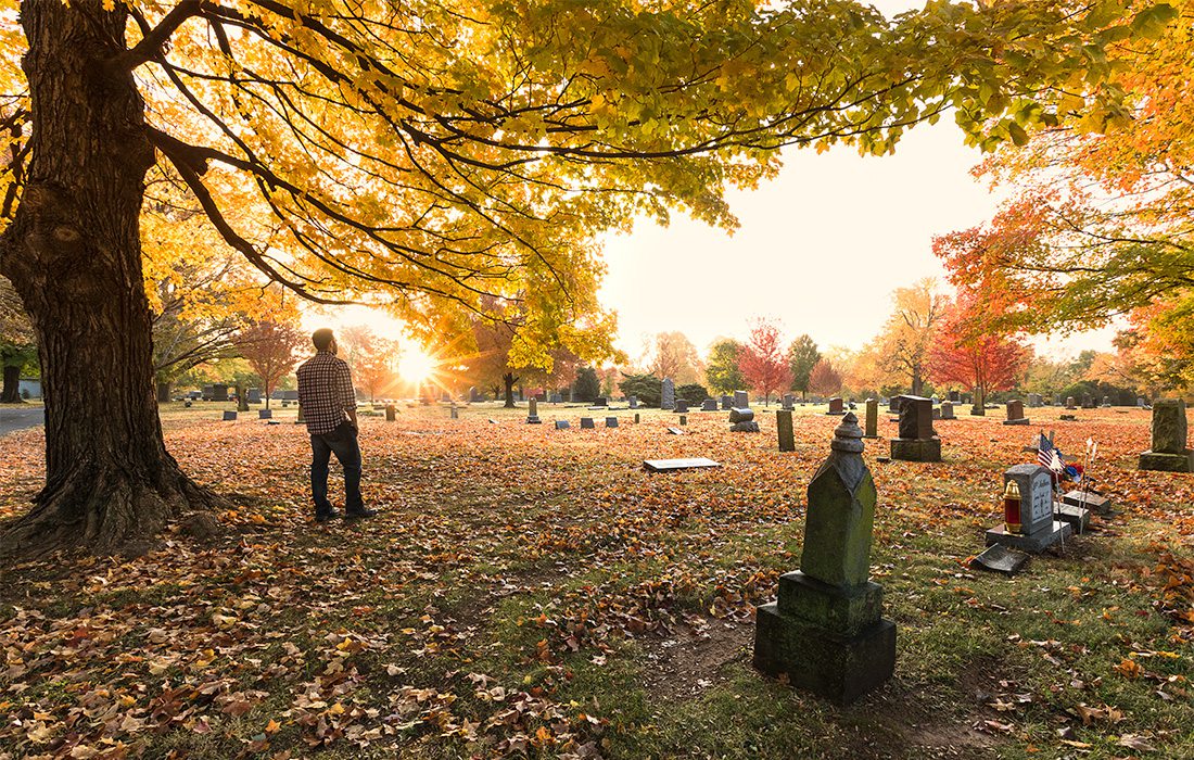 man in cemetery in fall