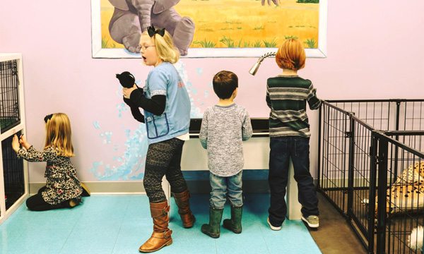 Children playing with animals