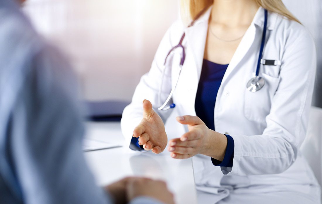 Doctor white lab coat holds COVID vaccine