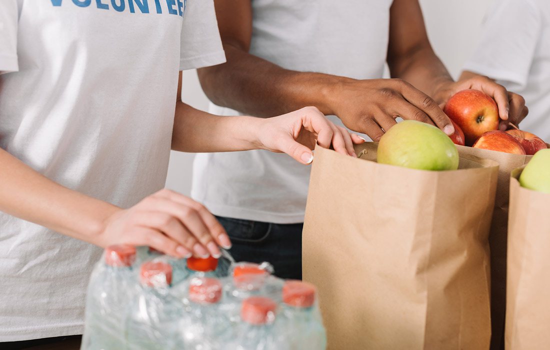 Stock image of volunteers with food donations