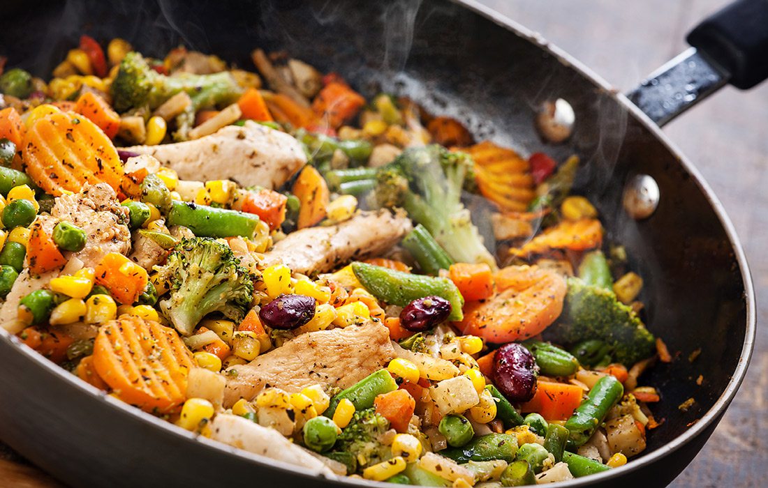 Stock image of stir fry cooking in a wok