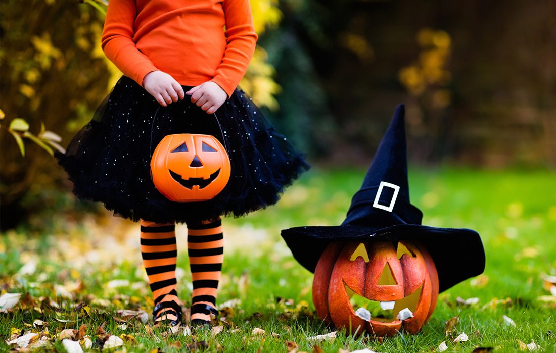 Girl holding Halloween candy bucket