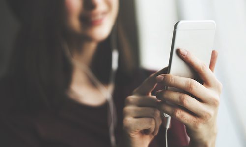 Woman listening to podcast on her phone