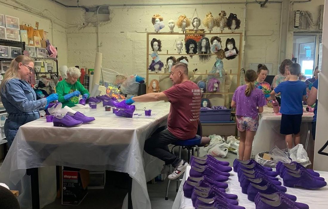 Volunteers of Springfield Little Theatre sewing together costumes for an upcoming show.