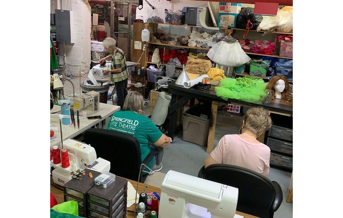 Volunteers of Springfield Little Theatre designing outfits for an upcoming show.