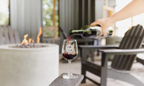 Pouring red wine by a fire pit at Bear Creek Winery & Brewery near Branson